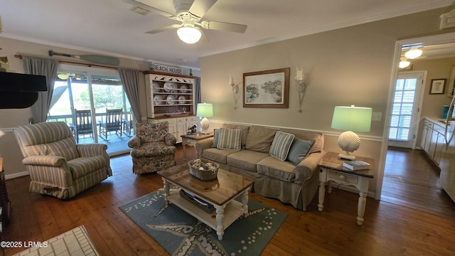 living room with crown molding, a healthy amount of sunlight, and wood-type flooring