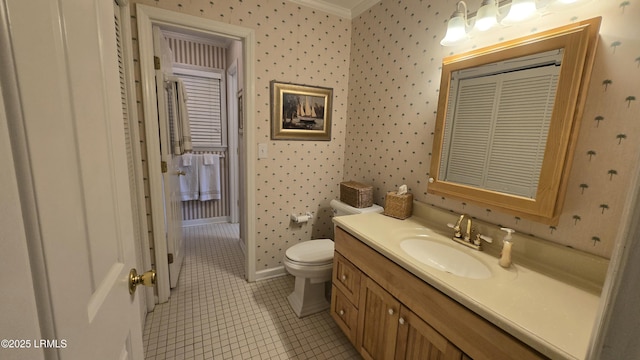 bathroom with tile patterned flooring, toilet, wallpapered walls, and vanity