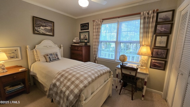 bedroom with baseboards, carpet floors, ceiling fan, a closet, and crown molding