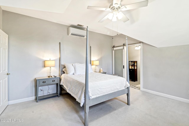 bedroom with light colored carpet, a wall unit AC, baseboards, and a barn door