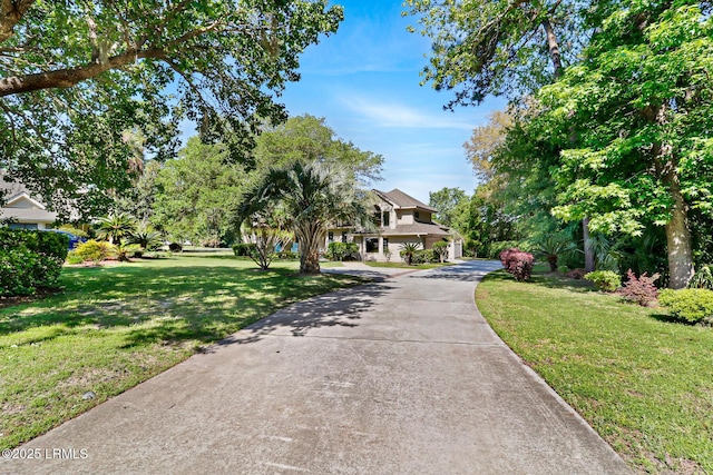 view of front of house with a front yard and concrete driveway