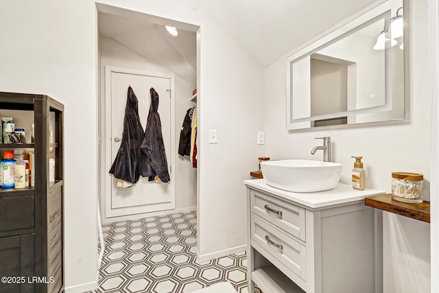 bathroom featuring vaulted ceiling and vanity