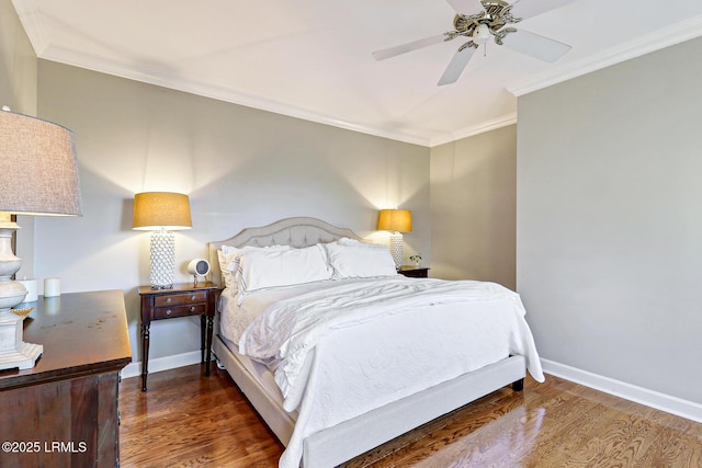 bedroom with baseboards, ceiling fan, wood finished floors, and crown molding