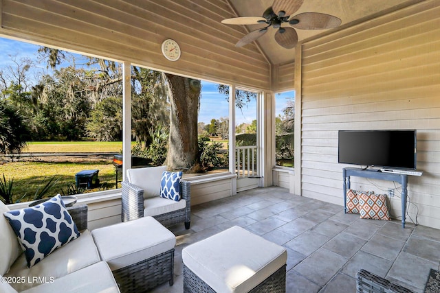 sunroom / solarium featuring ceiling fan and vaulted ceiling