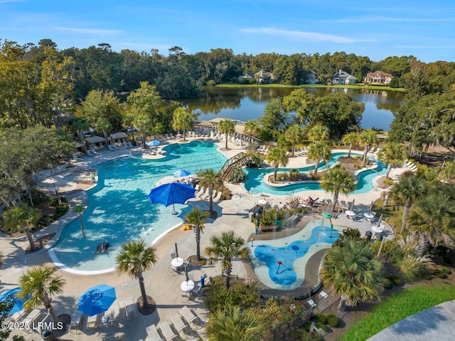 community pool with a patio area and a water view