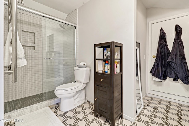 full bath featuring baseboards, a shower stall, toilet, and tile patterned floors