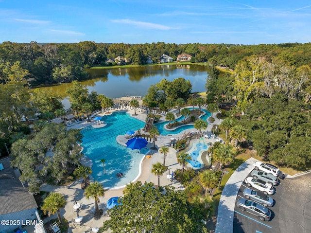 birds eye view of property featuring a water view and a forest view