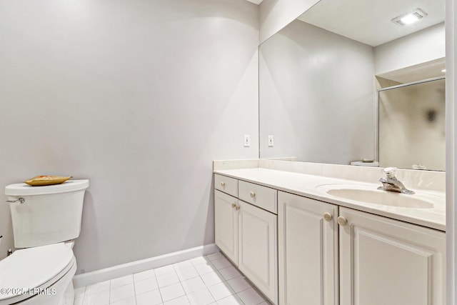 bathroom featuring toilet, vanity, baseboards, tile patterned floors, and a stall shower