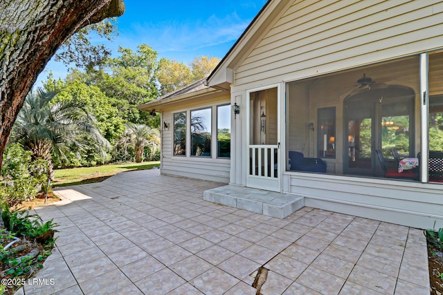 view of patio featuring a sunroom