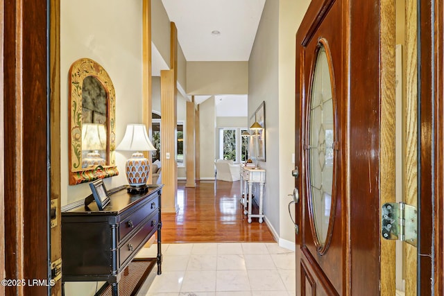 foyer featuring baseboards