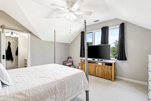 bedroom featuring light carpet, a barn door, visible vents, baseboards, and vaulted ceiling