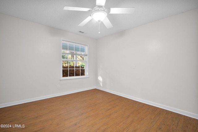 spare room featuring hardwood / wood-style floors and ceiling fan