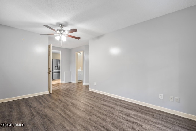 unfurnished room with a textured ceiling, dark hardwood / wood-style floors, and ceiling fan