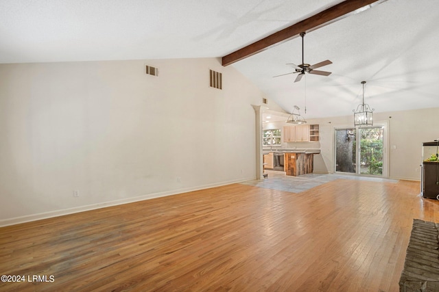 unfurnished living room featuring vaulted ceiling with beams, ceiling fan with notable chandelier, and light hardwood / wood-style floors