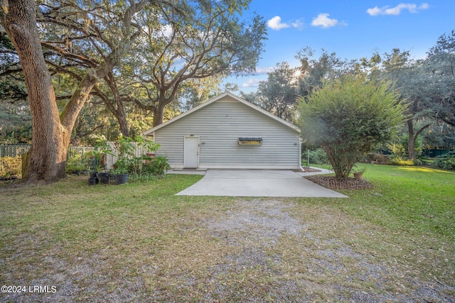 rear view of house with a patio and a lawn