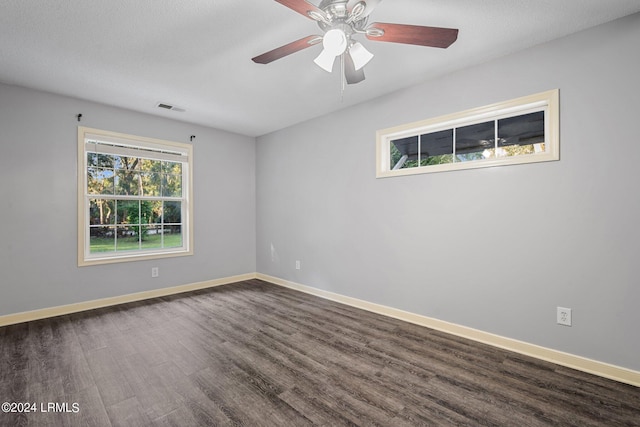 spare room featuring ceiling fan and dark hardwood / wood-style flooring