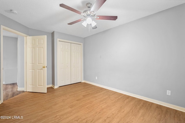 unfurnished bedroom with ceiling fan and light hardwood / wood-style floors