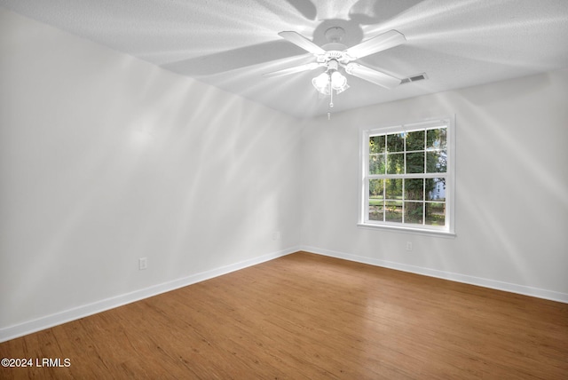 spare room featuring hardwood / wood-style flooring and ceiling fan