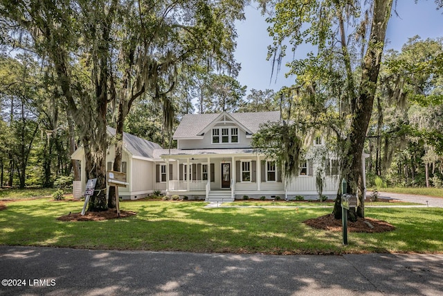 farmhouse-style home with a front yard and a porch