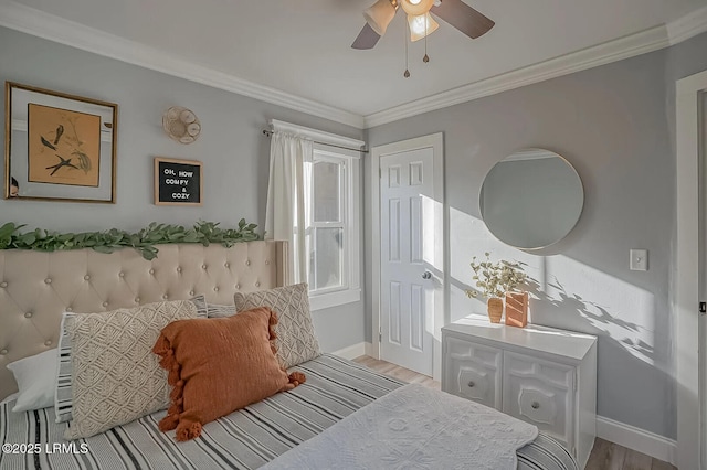 bedroom with ceiling fan, baseboards, wood finished floors, and crown molding