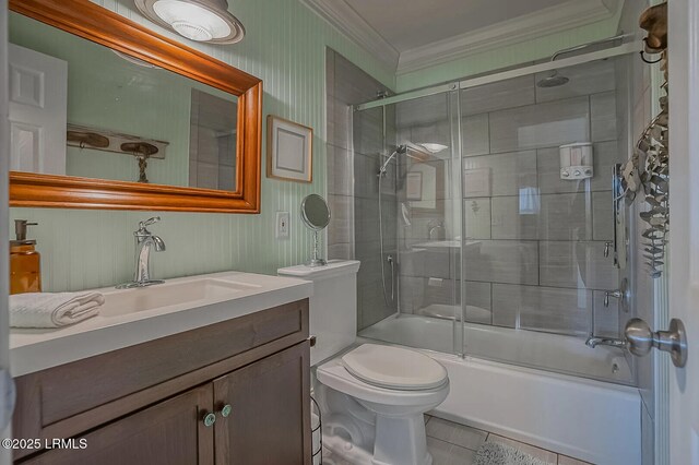 bathroom with tile patterned floors, toilet, combined bath / shower with glass door, crown molding, and vanity