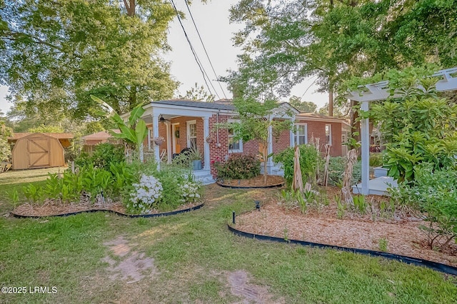 view of yard with a shed, a porch, and an outdoor structure