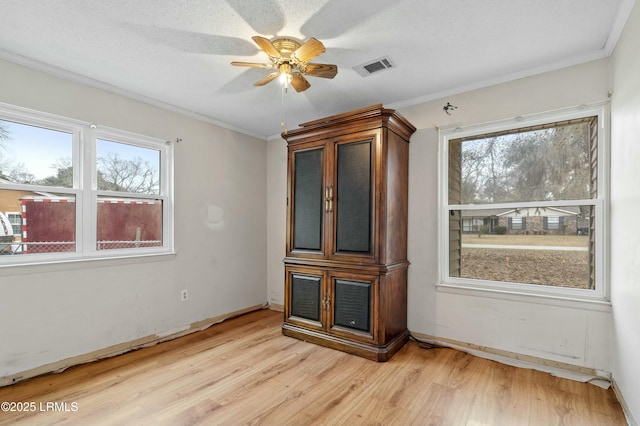 1986 Pulaski Dr, Beaufort, SC 29906 - unfurnished room with ceiling fan, light wood-style floors, visible vents, and ornamental molding