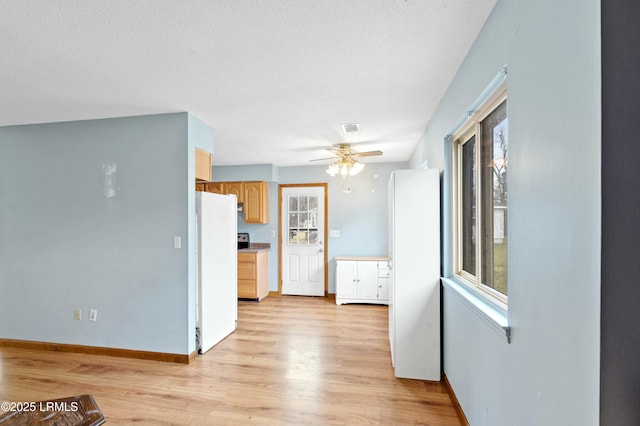 1986 Pulaski Dr, Beaufort, SC 29906 - kitchen featuring visible vents, baseboards, light wood-style flooring, and freestanding refrigerator