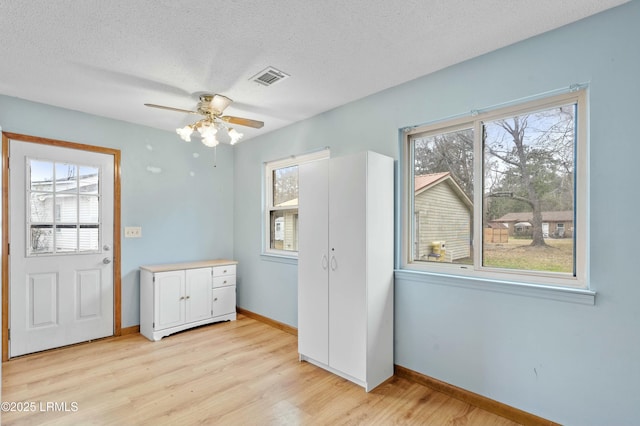 1986 Pulaski Dr, Beaufort, SC 29906 - interior space with baseboards, a textured ceiling, and light wood-style flooring