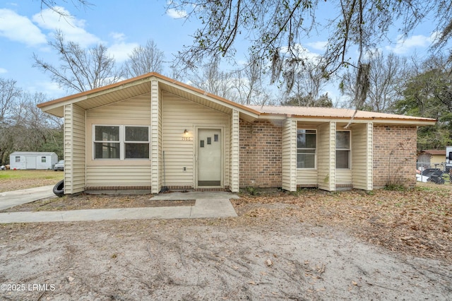 1986 Pulaski Dr, Beaufort, SC 29906 - view of front of home with brick siding and metal roof