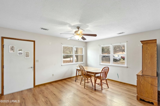 1986 Pulaski Dr, Beaufort, SC 29906 - dining area with a textured ceiling, light wood-style floors, visible vents, and baseboards