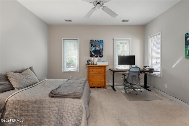 bedroom featuring light carpet and ceiling fan