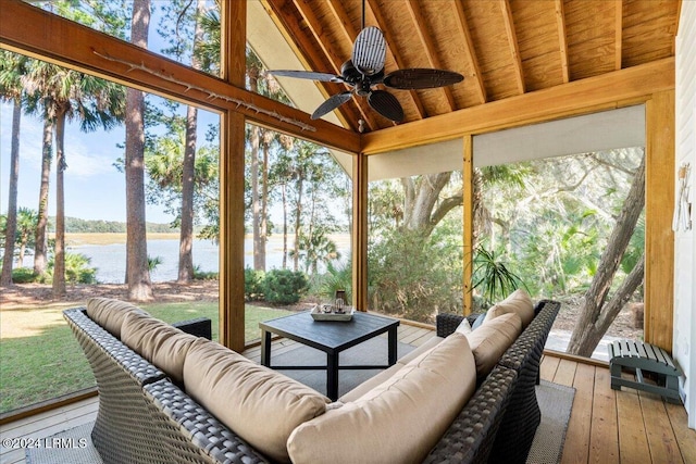 sunroom featuring a water view, vaulted ceiling with beams, ceiling fan, and plenty of natural light