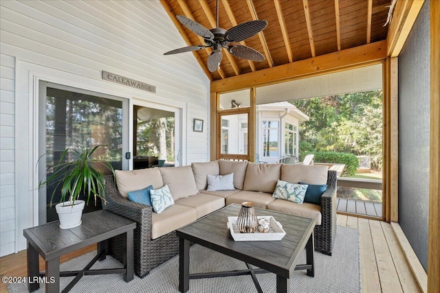 sunroom with vaulted ceiling with beams, wooden ceiling, and ceiling fan