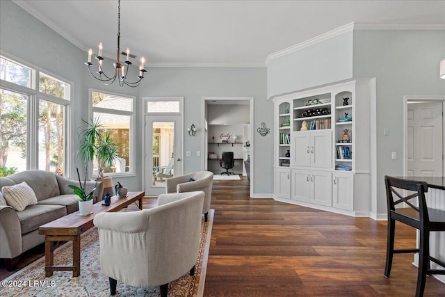 living room with an inviting chandelier, built in features, ornamental molding, and dark hardwood / wood-style floors