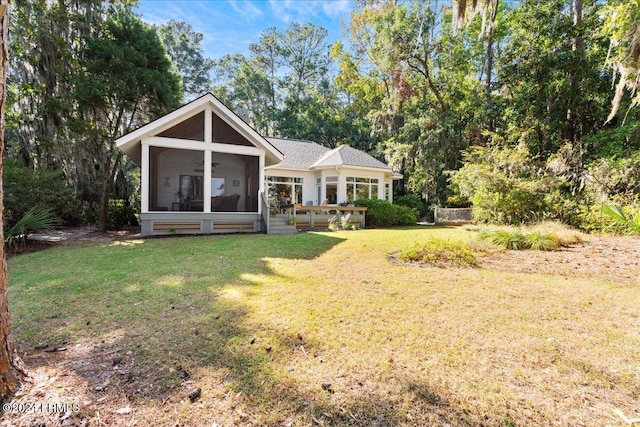 view of front of home featuring a front lawn and a sunroom