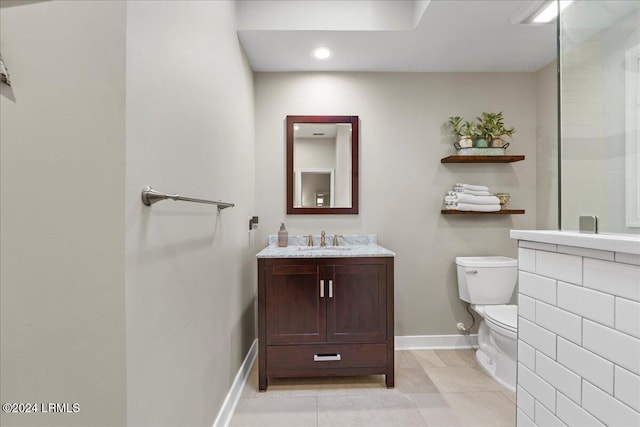 bathroom with tile patterned flooring, vanity, and toilet