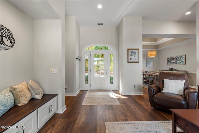 entrance foyer with dark wood-type flooring and ornamental molding