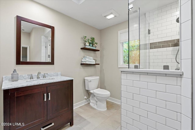 bathroom with vanity, a shower, tile patterned floors, and toilet