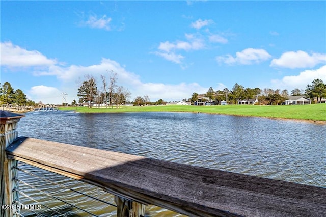 view of dock featuring a water view and a lawn