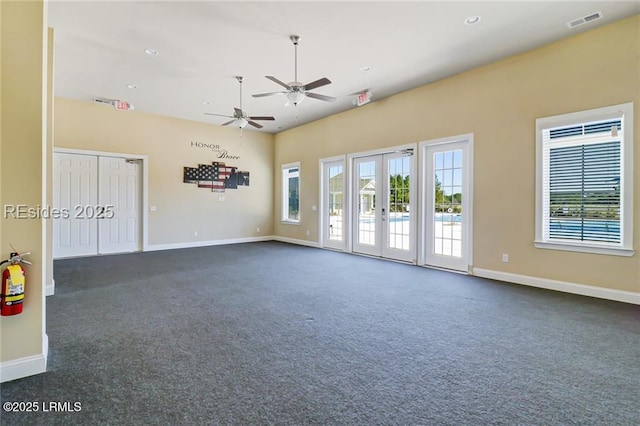 carpeted empty room featuring french doors and ceiling fan