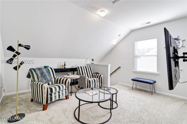sitting room featuring lofted ceiling and light carpet