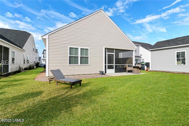 rear view of property with a yard and a sunroom