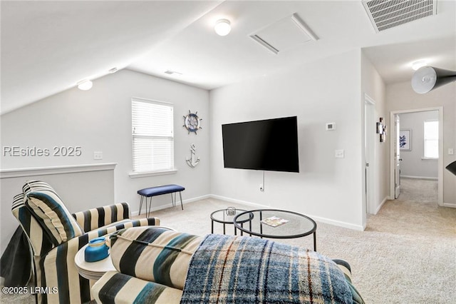 carpeted living room featuring lofted ceiling