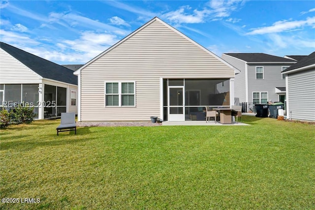 rear view of house featuring a patio, a sunroom, and a lawn