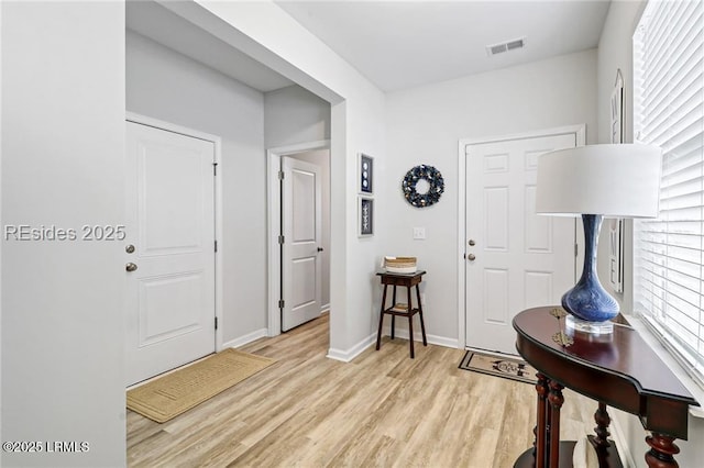 entryway with light hardwood / wood-style floors