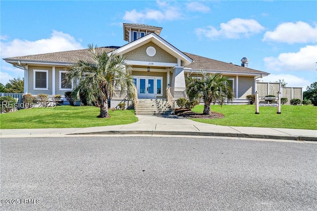 view of front of house with french doors and a front yard