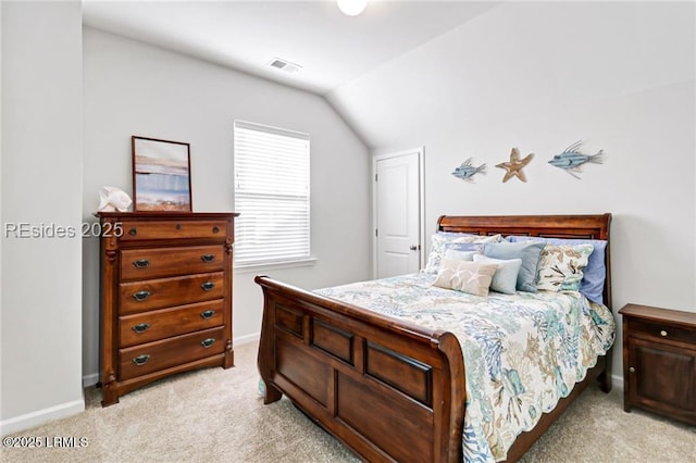 bedroom with light colored carpet and vaulted ceiling