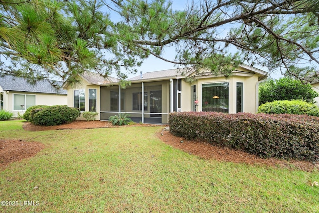 7 Fenwick Dr, Bluffton, SC 29909 - back of property featuring a sunroom, a yard, and stucco siding
