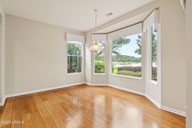 7 Fenwick Dr, Bluffton, SC 29909 - spare room with light wood finished floors, baseboards, and a water view